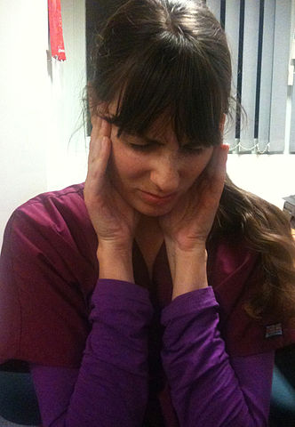 Image of woman in pain holding her jaw.