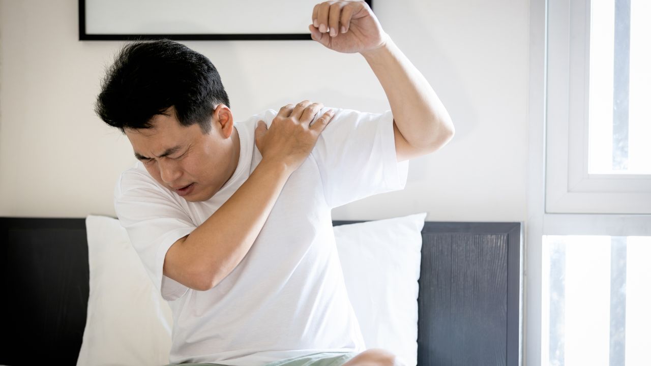 image of a man holding his shoulder in pain